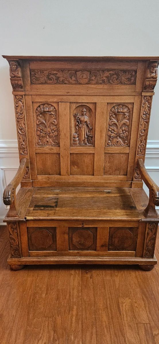 1800s GERMAN ANTIQUE CARVED OAK HALL BENCH / SETTEE / CHURCH PEW— Beautifully crafted solid oak bench featuring extensive hand-carved floral, scroll and figural details, paneled back and seat, carved arms and turned feet. A striking statement piece with exceptional craftsmanship and character. 