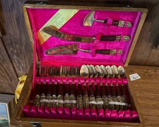 Silverware set in cabinet.