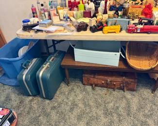 Antique and more recent suitcases. Coffee table. Avon cars.