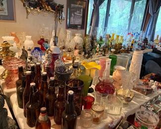 Extensive glass collection, including vintage and recent oil lamps.