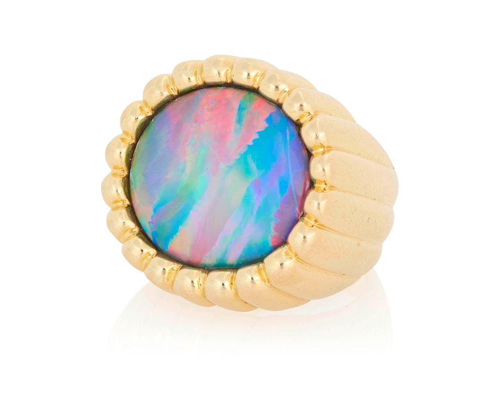 1 An 18K Gold and Black Opal Ring Of a high polish fluted design centering an oval black opal cabochon measuring approximately 18.22 x 14.58 x 3.05 mm  Size: 5 1/2 15.8 grams gross Estimate: $3,500 - $5,500