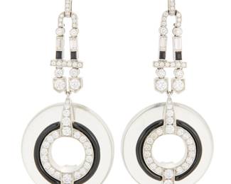128 A Pair of Platinum, Rock Crystal Quartz and Onyx Earrings Of a drop design suspending carved rock crystal quartz discs accented by onyx and finished with baguette and round diamonds weighing approximately 3.90 carats 2 pieces Measures: 2 1/2 x 1 in. 28.2 grams gross Estimate: $6,000 - $8,000