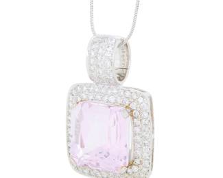 63 A White Gold, Platinum, Kunzite and Diamond Necklace Centering an emerald mixed-cut kunzite weighing approximately 30.00 carats, accented by a white gold frame set with round diamonds weighing approximately 1.65 carats Chain: 15 in., Pendant: 1 1/2 x 1 in. 19.3 grams gross Estimate: $3,000 - $5,000