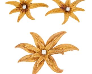 30 An 18K Gold and Diamond Brooch and Earring Set Of a flower motif, centering round diamonds 3 pieces Brooch: 2 1/2 x 1 1/2 in., Earrings: 1 1/4 x 7/8 in. 21.7 grams gross Estimate: $2,000 - $2,500