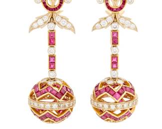 53 A Pair of 14K Gold, Ruby and Diamond Earrings Of a pendant design featuring a floral motif suspending a sphere all set with square-cut rubies and accented by round diamonds weighing approximately 5.20 carats total 2 pieces Measures: 2 x 3/4 in. 23.4 grams gross This lot is offered at no reserve. Estimate: $2,500 - $3,500