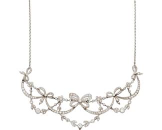 224 A Platinum, 18K Gold, Emerald and Diamond Necklace Of a bunting design accented by bow motifs, set with old European-cut and single-cut diamonds weighing approximately 6.75 carats, suspending a pear-shaped emerald weighing approximately 1.93 carats Length: 15 in. 22.3 grams gross Estimate: $7,500 - $9,500