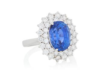 187 An 18K White Gold, Sapphire and Diamond Ring Centering an oval sapphire weighing approximately 7.40 carats, encircled by two rows of round diamonds weighing approximately 1.55 carats Size: 7 1/4 8.0 grams gross Accompanied by a GIA Report numbered #2235696474, dated September 22, 2025, stating the Sapphire as natural Corundum of Sri Lankan origin with heat enhancement. Estimate: $12,000 - $18,000
