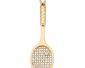 284 An 18K Gold and Diamond Pendant Of a tennis racquet design featuring a single round diamond Measures: 3 x 7/8 in. 12.8 grams gross Estimate: $1,500 - $2,000