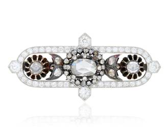 115 A Platinum, Gold and Diamond Brooch Featuring a platinum Cartier frame set with old European-cut diamonds weighing approximately 1.80 carats, centering an ornate 8k gold center featuring oval and round rose-cut diamonds Measures: 2 x 7/8 in. 12.8 grams gross Estimate: $5,500 - $7,500