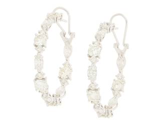 231 A Pair of 14K White Gold and Diamond Earrings Of a hoop design featuring marquise-shaped and round diamonds weighing approximately 7.80 carats 2 pieces Measures: 1 1/4 in. 9.1 grams gross Estimate: $4,000 - $6,000