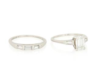 118 A Platinum and Diamond Ring Set Including an engagement ring, centering an emerald-cut diamond weighing 1.00 carat, accented by baguette diamonds, together with a band featuring three baguette diamonds Size: 7 3/4 7.40 grams gross Estimate: $2,500 - $3,500