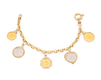 139 A Gold, Platinum and Diamond Coin Bracelet An 18k gold coin charm bracelet, suspending five-coin charms, including 24k gold Aries, Chinese panda, and ballerina bank of Russia coins, together with platinum Maple Leaf and the Isle of Man coins Length: 7 1/8 in. 23.6 grams gross Estimate: $2,000 - $3,000