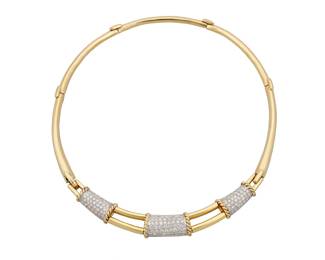 286 An 18K Bi-Color Gold and Diamond Necklace Including a central panel featuring three bands of white gold set with round diamonds weighing approximately 5.30 carats, accented by a twisted yellow gold design Length: 15 in. 60.4 grams gross Estimate: $7,000 - $10,000