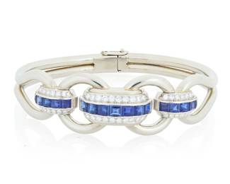 184 An 18K White Gold, Sapphire and Diamond Bracelet Of an open link design featuring domed channels set with sapphires and single-cut diamonds, estimated total diamond weight 1.35 carats Inner Circumference: 7 in. 32.7 grams gross Estimate: $5,000 - $7,000