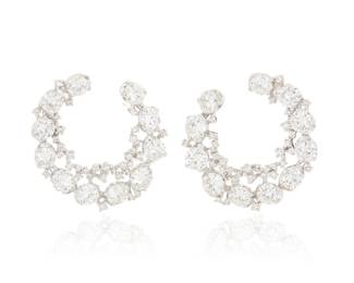 46 A Pair of 14K White Gold and Diamond Earrings Of an ornate crescent design set with round diamonds weighing approximately 6.75 carats total 2 pieces Measures: 1 x 1 in. 9.2 grams gross Estimate: $3,000 - $5,000