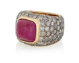 220 Verney: An 18K Bi-Color Gold, Ruby and Colored Diamond Ring Centering a sugarloaf cabochon ruby weighing approximately 11.88 carats, accented by graduated round grey diamonds weighing approximately 8.90 carats, signed Verney, Paris Size: 6 1/2 22.9 grams gross Estimate: $5,000 - $7,000