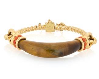146 Chaumet: An 18K Gold, Tiger's Eye and Coral Bracelet Featuring a carved domed tiger's eye element, accented by ten round coral cabochons, flanked by a twisted rope design, signed Chaumet, Paris Inner Circumference: 6 1/4 in. 44.2 grams gross Estimate: $6,000 - $8,000