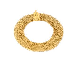 28 A 22K Gold Bracelet Of a mesh link design with a pin style clasp Length: 7 1/8 in,. Width: 1/2 in. 20.7 grams gross approximately 7" long Estimate: $2,000 - $3,000