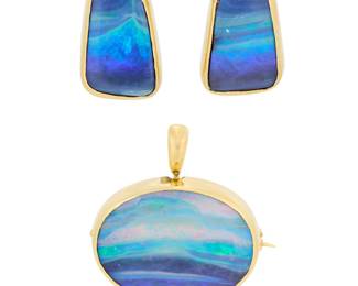 77 An 18K Gold and Boulder Opal Set Including a brooch/pendant and a pair of earrings of an organic design featuring boulder opals measuring approximately 21.10 x 16.0 x 5.60 mm and 14.70 x 8.70 x 3.52 mm 3 pieces Brooch: 7/8 x 5/8 in., Earrings: 5/8 x 3/8 in. 14.3 grams gross Estimate: $2,000 - $3,000