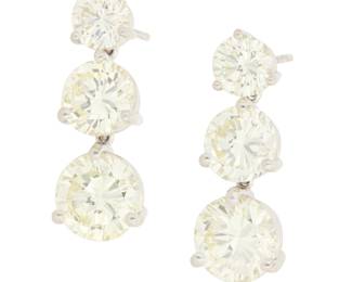 243 A Pair of 18K White Gold and Diamond Earrings Featuring six graduated diamonds weighing approximately 7.75 carats total 2 pieces Measures: 7/8 x 3/8 in. 5.5 grams gross Estimate: $9,000 - $12,000
