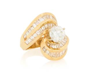 272 A 14K Gold and Diamond Ring Centering a round diamond weighing approximately round 1.45 carats, mounted in a swirling design set with tapered baguette diamonds weighing approximately 1.90 carats Size: 4 1/2 10.6 grams gross Estimate: $3,000 - $5,000