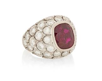 51 A 18K White Gold, Ruby and Diamond Ring Featuring a cushion-cut ruby weighing approximately 5.60 carats, accented by round brilliant-cut diamonds weighing approximately 2.30 carats total Size: 4 3/4 10.0 grams gross Accompanied by a copy of an LFG report stating the ruby is natural, Burma origin with no heat treatment. Estimate: $28,000 - $35,000