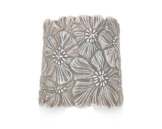 37 Buccellati: A Sterling Silver Cuff Featuring a garden of blossoming flowers, signed Buccellati, with Italian workshop marks, Italy Measures: 5 1/2 in., Gap: 1 in. 99.5 grams gross Estimate: $1,200 - $1,800