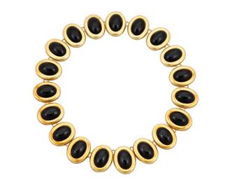 89 An 18K Gold and Onyx Necklace Featuring nineteen oval links centering oval onyx cabochons Length: 15 in., Width: 1 in. 110.9 grams gross Estimate: $3,000 - $5,000