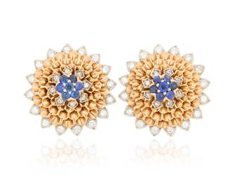 197 Cartier: A Pair of 14K Bi-Color Gold, Sapphire and Diamond Earrings Of a blossoming floral design featuring unfolding petals of rose gold, accented by white gold set with round and single-cut diamonds weighing approximately 1.30 carats, finished with fourteen round sapphires, signed Cartier 2 pieces Measures: 1 x 1 in. 20.9 grams gross Estimate: $3,500 - $5,500