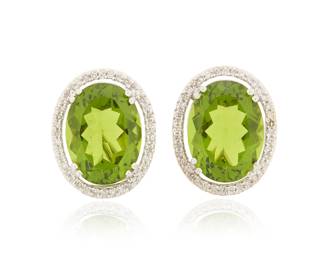 106 A Pair of 14K White Gold, Peridot and Diamond Earrings Centering two oval peridots weighing approximately 8.90 and 9.90 carats, encircled by single-cut diamonds weighing approximately 0.80 carat 2 pieces Measures: 3/4 x 1/2 in. 10.5 grams gross Estimate: $2,500 - $3,500