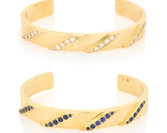 157 Bulgari: A Pair of 18K Gold, Diamond and Sapphire Cuffs Of a high polish design, one featuring round diamonds weighing approximately 1.28 carats, the other accented by round sapphires, signed Bulgari with Italian workshop marks 2 pieces Measures: 4 3/4 in., Gap: 1 1/4 in. 76.3 grams gross Estimate: $18,000 - $25,000