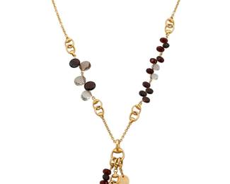 15 Gucci: An 18K Gold, Smoky Quartz and Garnet Necklace Featuring stirrup style gold links accented by oval faceted garnet and smoky quartz, signed Gucci, with Italian assay marks Chain: 20 in., Tassel: 2 3/4 in. 38.0 grams gross Estimate: $3,500 - $5,500