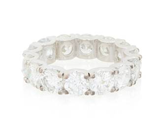 297 A 14K White Gold and Diamond Eternity Band Featuring fourteen round diamonds weighing 8.53 carats Size: 8 6.3 grams gross Estimate: $4,000 - $6,000