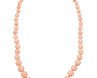 241 An 18K Gold and Coral Necklace Of a single strand design featuring graduated round coral beads measuring approximately 6.31 - 16.72 mm, finished with an 18k gold and coral clasp Length: 22 1/2 in. 84.4 grams gross Estimate: $1,500 - $2,000