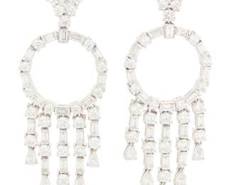229 A Pair of Platinum and Diamond Earrings Of an open ring and fringe design, set with alternating baguette and round diamonds weighing approximately 7.10 carats 2 pieces Measures: 2 1/8 x 7/8 in. 26.7 grams gross Estimate: $6,000 - $8,000