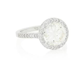45 An 18K White Gold and Diamond Ring Centering a round diamond weighing 2.65 carats, accented by single-cut diamonds in a halo design Size: 7 1/2 4.7 grams gross Estimate: $6,500 - $8,500