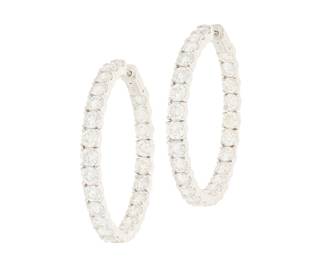 234 A Pair of 14K White Gold and Diamond Hoop Earrings Of a hoop design featuring fifty round diamonds weighing approximately 10.75 carats total 2 pieces Measures: 1 1/2 in. 14.9 grams gross Estimate: $6,000 - $8,000