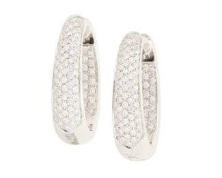 101 A Pair of 18K White Gold and Diamond Hoop Earrings Featuring round diamonds weighing approximately 4.65 carats, set half on the inside and half of the front of a tapered design 2 pieces Measures: 1 1/8 x 7/8 in. 23.7 grams gross Estimate: $3,500 - $5,500