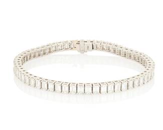 179 A Platinum and Diamond Bracelet Of a single line design featuring fifty-eight emerald-cut diamonds weighing approximately 10.60 carats Length: 7 1/4 29.0 grams gross Estimate: $12,000 - $18,000
