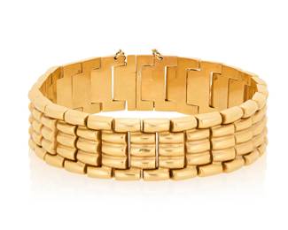 148 An 18K Gold Bracelet Of a high polish brick link design Length: 7 1/4 in., Width: 5/8 in. 31.2 grams gross Estimate: $2,500 - $3,500