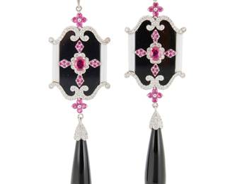 69 A Pair of 18K White Gold, Ruby and Onyx Earrings Of an ornate design featuring tablets and drops of onyx and white agate, accented by round and oval rubies, finished with accents of round diamonds, marked HK 2 pieces Measures: 3 1/4 x 3/4 in. 20.0 grams gross Estimate: $1,800 - $2,200