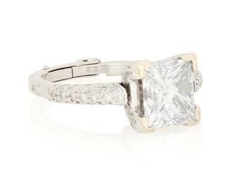 47 A 14K White Gold and Diamond Ring Centering a princess-cut diamond weighing 3.05 carats, accented by round diamonds and finished with a hinged shank Size: 7 1/2 6.9 grams gross Accompanied by a GIA Report numbered #2235891916, dated March 02, 2026, stating the 3.05 carat diamond as Natural with a color grade of E and a clarity grade of VVS2, no fluorescence. Estimate: $20,000 - $25,000