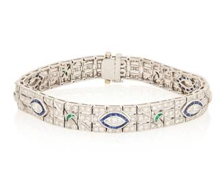 190 An 18K White Gold, Diamond And Gem-Set Bracelet Of a geometric link design centering five marquise-shaped diamonds accented by round diamonds weighing approximately 5.50 carats, finished with French-cut sapphires and emeralds Length: 7 in. 31.1 grams gross Estimate: $7,000 - $10,000