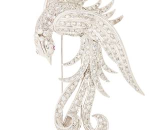 117 A 14K White Gold and Diamond Bird Brooch Of a bird design with cascading feather set with single-cut diamonds weighing approximately 9.60 carats, finished with two single-cut ruby eyes Measures: 3 1/2 x 2 1/2 in. 41.6 grams gross Estimate: $5,500 - $7,500