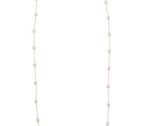 293 A 14K Gold and Diamond Necklace Of a station design featuring twenty-four round diamonds weighing approximately 4.75 carats Length: 35 in. 8.6 grams gross Estimate: $4,500 - $5,500