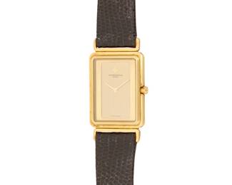 303 Vacheron Constantin: An 18K Gold 'Harmony' Watch Dial: 17.60 mm, rectangular gold dial with no hour markers Case: 23.00 mm Case number: 566613 Closure: black leather strap with 18k gold buckle clasp Signed: dial, case and clasp Inner circumference: 6 3/4 - 8 1/2 in. 33.0 grams gross Estimate: $5,000 - $7,000