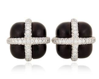 98 Seaman Schepps: A Pair of 18K White Gold, Diamond, and Ebony Wood Earrings Of a cross over design set with round diamonds weighing approximately 2.40 carats, signed Seaman Schepps, with signed box 2 pieces Measures: 3/4 x 3/4 in. 20.4 grams gross Estimate: $5,500 - $7,500
