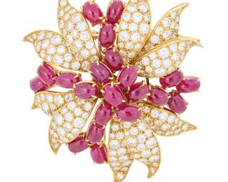 57 An 18K Gold, Ruby and Diamond Pin Of a foliate design featuring leaves set with round diamonds weighing approximately 9.00 carats, accented by twenty-one oval cabochon rubies Measures: 2 x 2 in. 29.5 grams gross Estimate: $6,000 - $8,000