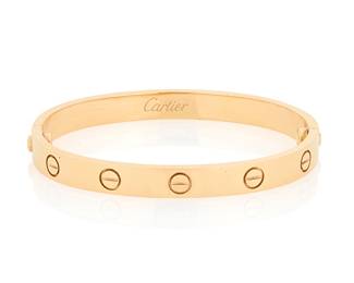 6 Cartier: An 18K Gold 'Love' Bangle Of a high polish design featuring ten screw motifs and two screws, signed Cartier, 16, FW3256 Inner Circumference: 6 in. 31.9 grams gross Estimate: $3,500 - $5,500