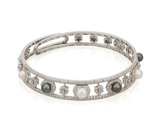230 An 18K White Gold, Cultured Pearl and Diamond Collar Necklace Of a banded design featuring seven grey and white cultured pearls measuring approximately 8.40 mm, accented by round diamonds weighing approximately 7.05 carats set in a floral design Measures: 16 in. 101.5 grams gross Estimate: $15,000 - $20,000